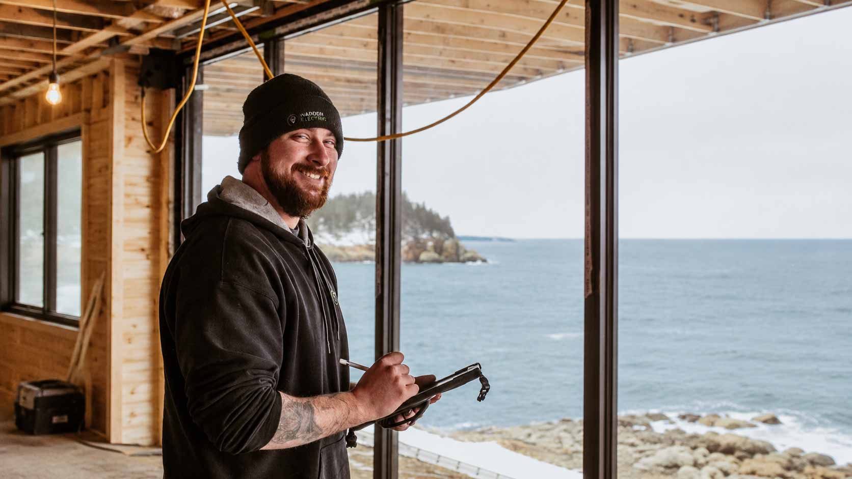 Wadden Electric team member on-site at an oceanfront residential project in Nova Scotia