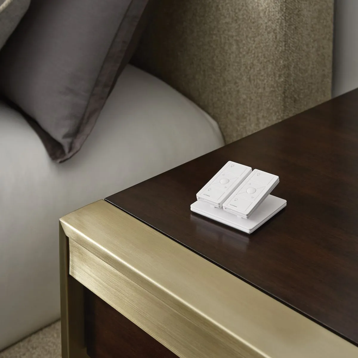 Lutron Pico remotes on brass and walnut bedside table